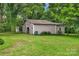 Spacious outbuilding on a lush green lawn, perfect for a workshop or storage with additional shed space at 1607 Old Lawyers Rd, Marshville, NC 28103