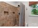 Tiled shower stall with built in shelving and shower curtain at 1607 Old Lawyers Rd, Marshville, NC 28103