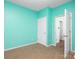 Bright bedroom with colorful blue accent walls, carpet and a door to hallway at 170 Atwater Landing Dr, Mooresville, NC 28117