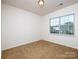 Well-lit bedroom with carpet, a window and neutral color scheme at 170 Atwater Landing Dr, Mooresville, NC 28117