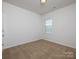 Clean bedroom with plush carpet, a window for natural light, and freshly painted walls at 170 Atwater Landing Dr, Mooresville, NC 28117