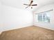 Bright bedroom featuring a ceiling fan and large window for ample natural light at 170 Atwater Landing Dr, Mooresville, NC 28117