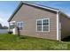 Side view of home with tidy lawn, horizontal siding and a glimpse of a covered porch at 170 Atwater Landing Dr, Mooresville, NC 28117