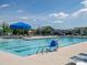 A community pool with lounge chairs, shade umbrellas and beautiful blue water at 170 Atwater Landing Dr, Mooresville, NC 28117