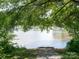 Scenic waterfront view of a calm river from a wooded lot providing a peaceful and serene atmosphere at 170 Atwater Landing Dr, Mooresville, NC 28117
