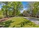 Expansive backyard with lush artificial turf, a trampoline, and a charming shed at 1726 The Plz, Charlotte, NC 28205