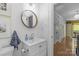 Modern bathroom with wood-framed mirror, hardwood floors, and white vanity at 1726 The Plz, Charlotte, NC 28205