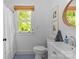 White bathroom featuring blue tile floors, a window, and modern fixtures at 1726 The Plz, Charlotte, NC 28205