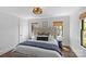 Bright bedroom with a large headboard, dark window trim, and decorative woven light fixture at 1726 The Plz, Charlotte, NC 28205