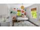 Charming bedroom with colorful accent wall, natural light, and a gray and blue rug at 1726 The Plz, Charlotte, NC 28205