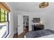 Bedroom with a doorway view to a hallway, dark wood floors, and woven ceiling light at 1726 The Plz, Charlotte, NC 28205