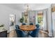 Elegant dining room with hardwood floors, white paneled walls and a wood table with blue chairs at 1726 The Plz, Charlotte, NC 28205