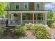Inviting covered front porch adorned with hanging ferns and columns at 1726 The Plz, Charlotte, NC 28205