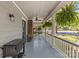 Covered front porch adorned with hanging ferns, ceiling fan and furniture at 1726 The Plz, Charlotte, NC 28205