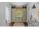 Hallway with built-in storage, wood floors, white shiplap, and a window with natural light at 1726 The Plz, Charlotte, NC 28205