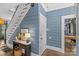 Entry hallway with staircase, desk and unique blue and white wallpaper at 1726 The Plz, Charlotte, NC 28205