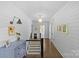 Upstairs hallway featuring shiplap walls, hardwood floors, and modern lighting at 1726 The Plz, Charlotte, NC 28205