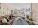 Bright living room with built-in shelving, a decorative fireplace, and comfortable seating at 1726 The Plz, Charlotte, NC 28205