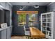 Home office features dark walls, a large window, and built in cabinets at 1726 The Plz, Charlotte, NC 28205
