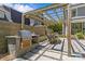 Backyard barbecue area with a wooden pergola and a built-in stainless steel grill at 1726 The Plz, Charlotte, NC 28205