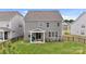 Backyard with a covered patio, fenced-in yard, and well-maintained lawn at 190 Tetcott St, Mooresville, NC 28115
