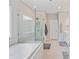Modern bathroom with a soaking tub, glass shower, and tile flooring at 190 Tetcott St, Mooresville, NC 28115