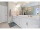 Bathroom featuring double sinks, white cabinets, and a glass-enclosed shower at 190 Tetcott St, Mooresville, NC 28115
