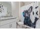 Bright bathroom featuring a white vanity with a granite countertop, a toilet and a shower with a dog curtain at 190 Tetcott St, Mooresville, NC 28115