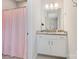 Neutral bathroom featuring a granite vanity, pink curtain and updated vanity lighting at 190 Tetcott St, Mooresville, NC 28115