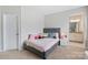 Neutral bedroom featuring a queen bed with ensuite bathroom with dual vanity, providing a private retreat at 190 Tetcott St, Mooresville, NC 28115