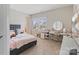 Bright bedroom with a desk, window, carpet, and a bed with pink accents at 190 Tetcott St, Mooresville, NC 28115