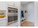 Built-in stainless steel double oven and custom storage with access to the garage at 190 Tetcott St, Mooresville, NC 28115