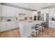 Bright, modern kitchen with white cabinets, stainless steel appliances, and a breakfast bar at 190 Tetcott St, Mooresville, NC 28115