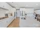 Kitchen with white cabinets, stainless steel appliances, and a view of the staircase at 190 Tetcott St, Mooresville, NC 28115