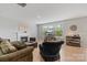 Inviting living room with a fireplace, comfortable seating, and natural light at 190 Tetcott St, Mooresville, NC 28115