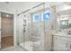 Luxurious bathroom with glass shower featuring tiled walls, a built-in bench, and updated fixtures at 2012 Embassy Ct # 46, Charlotte, NC 28213