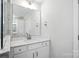 Well-lit bathroom featuring a modern vanity with sleek hardware, a large mirror, and neutral décor at 2012 Embassy Ct # 46, Charlotte, NC 28213