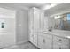 Clean bathroom featuring white cabinetry, a large mirror, and modern fixtures complemented by marble flooring at 2012 Embassy Ct # 46, Charlotte, NC 28213
