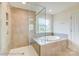 Modern bathroom features a glass-enclosed shower, soaking tub, and neutral tile at 2012 Embassy Ct # 46, Charlotte, NC 28213
