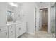 Bright bathroom featuring a white vanity, elegant marble countertops, and a glass-enclosed shower at 2012 Embassy Ct # 46, Charlotte, NC 28213