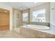 Contemporary bathroom with a glass-enclosed shower, a soaking tub, and ceramic tile flooring at 2012 Embassy Ct # 46, Charlotte, NC 28213