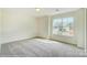 Bedroom with a large window and plush carpeting at 2012 Embassy Ct # 46, Charlotte, NC 28213