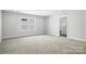 Bright bedroom featuring neutral carpet, a large window, and a convenient doorway to an ensuite bathroom at 2012 Embassy Ct # 46, Charlotte, NC 28213