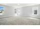 Well-lit bedroom showcasing neutral carpeting, ample natural light from multiple windows, and fresh white walls at 2012 Embassy Ct # 46, Charlotte, NC 28213