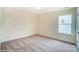 Bright bedroom featuring neutral walls, carpet floor, window and door at 2012 Embassy Ct # 46, Charlotte, NC 28213