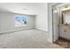 Bright, spacious bedroom with plush carpet, window and an adjoining bathroom with vanity at 2012 Embassy Ct # 46, Charlotte, NC 28213