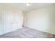 A simple bedroom with neutral carpet, two closets, and crisp white walls at 2012 Embassy Ct # 46, Charlotte, NC 28213