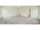 Bright bedroom with neutral carpeting and a doorway leading to a bathroom at 2012 Embassy Ct # 46, Charlotte, NC 28213