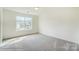 Bright bedroom featuring a large window offering neighborhood views at 2012 Embassy Ct # 46, Charlotte, NC 28213