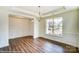 Dining room with classic wainscoting, chandelier, and large window with a view at 2012 Embassy Ct # 46, Charlotte, NC 28213